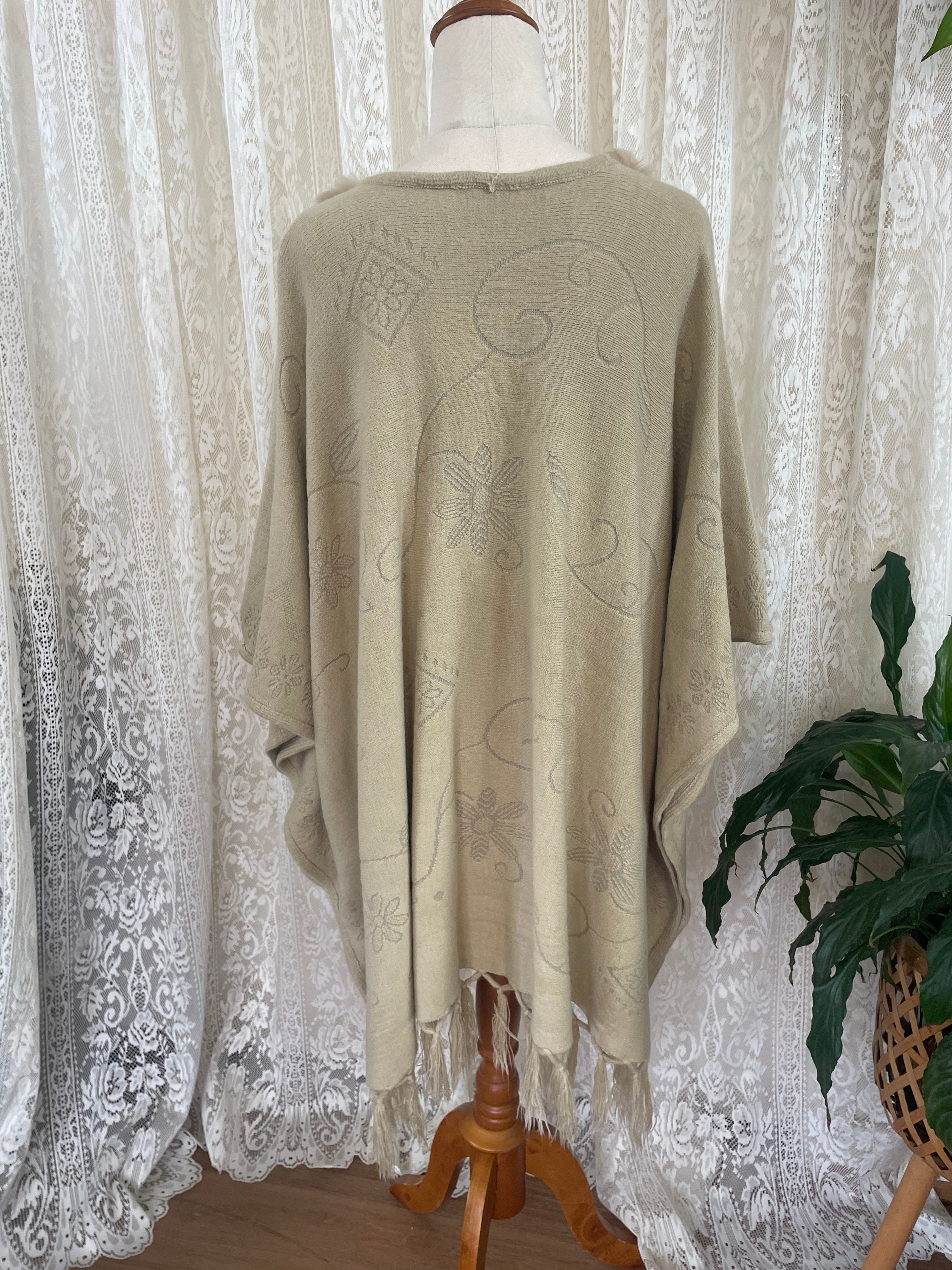 Cream boho poncho with pom poms, buttons and fringe