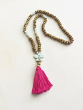 Long wood & white bead necklace with stone butterfly & pink tassel